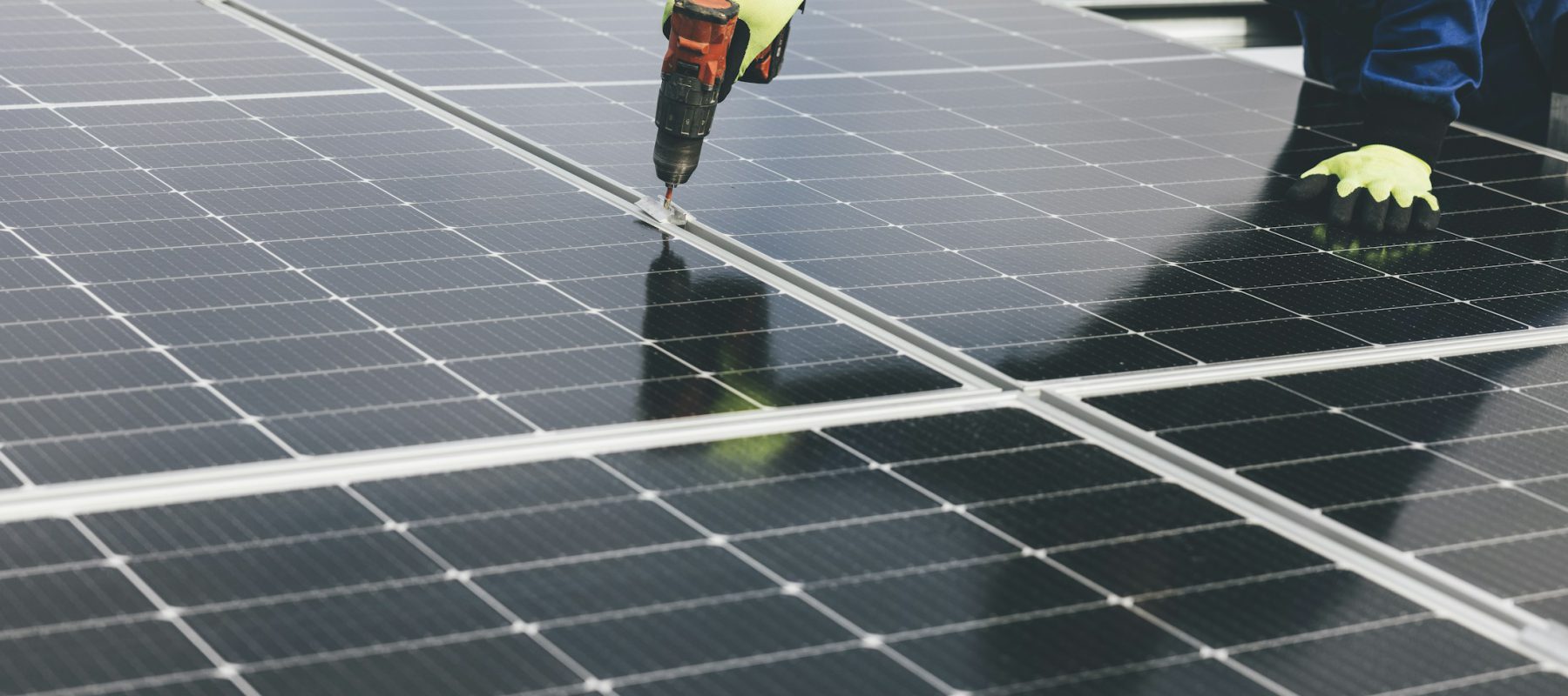 Solar professional working beside an energy installation
