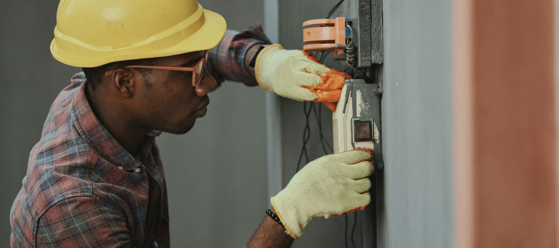 Electrician working with professional electrical equipment