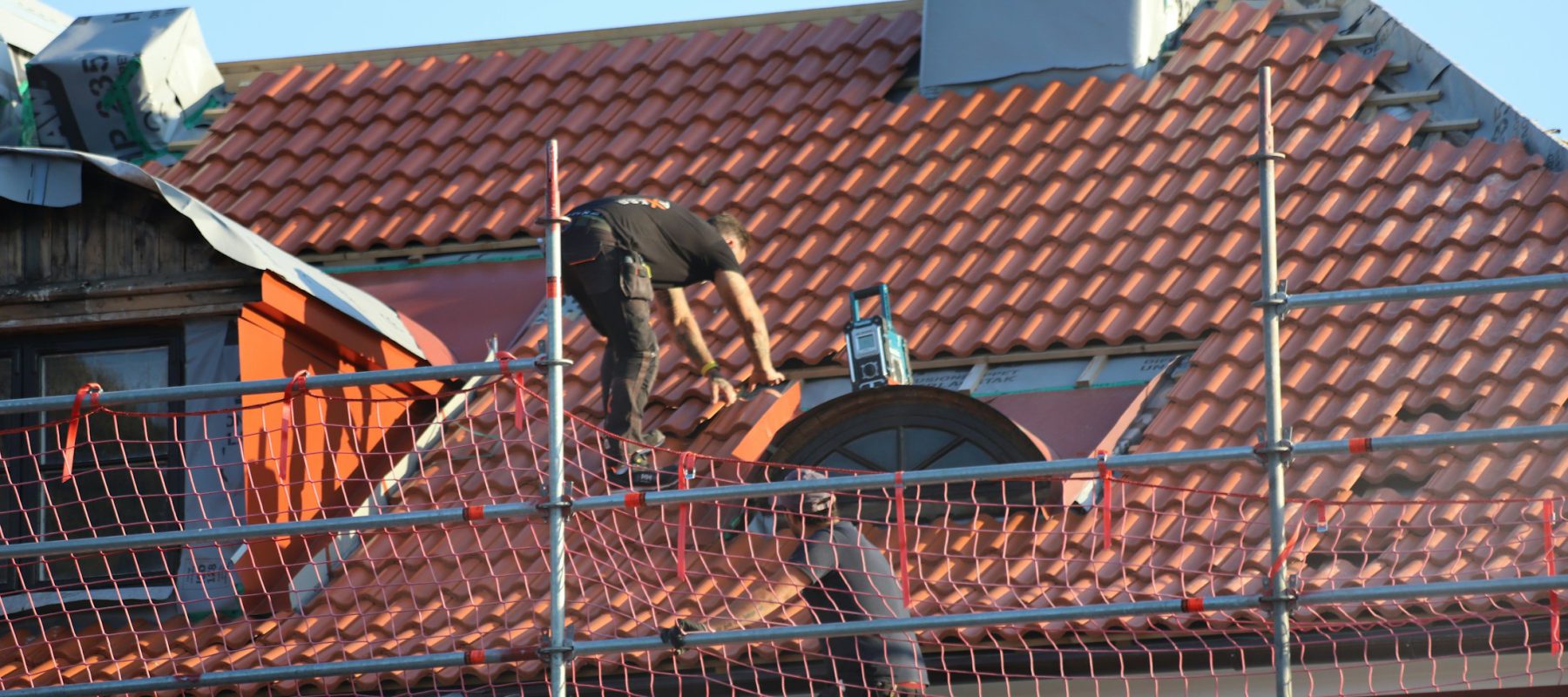 Roofing professional working on a residential roof