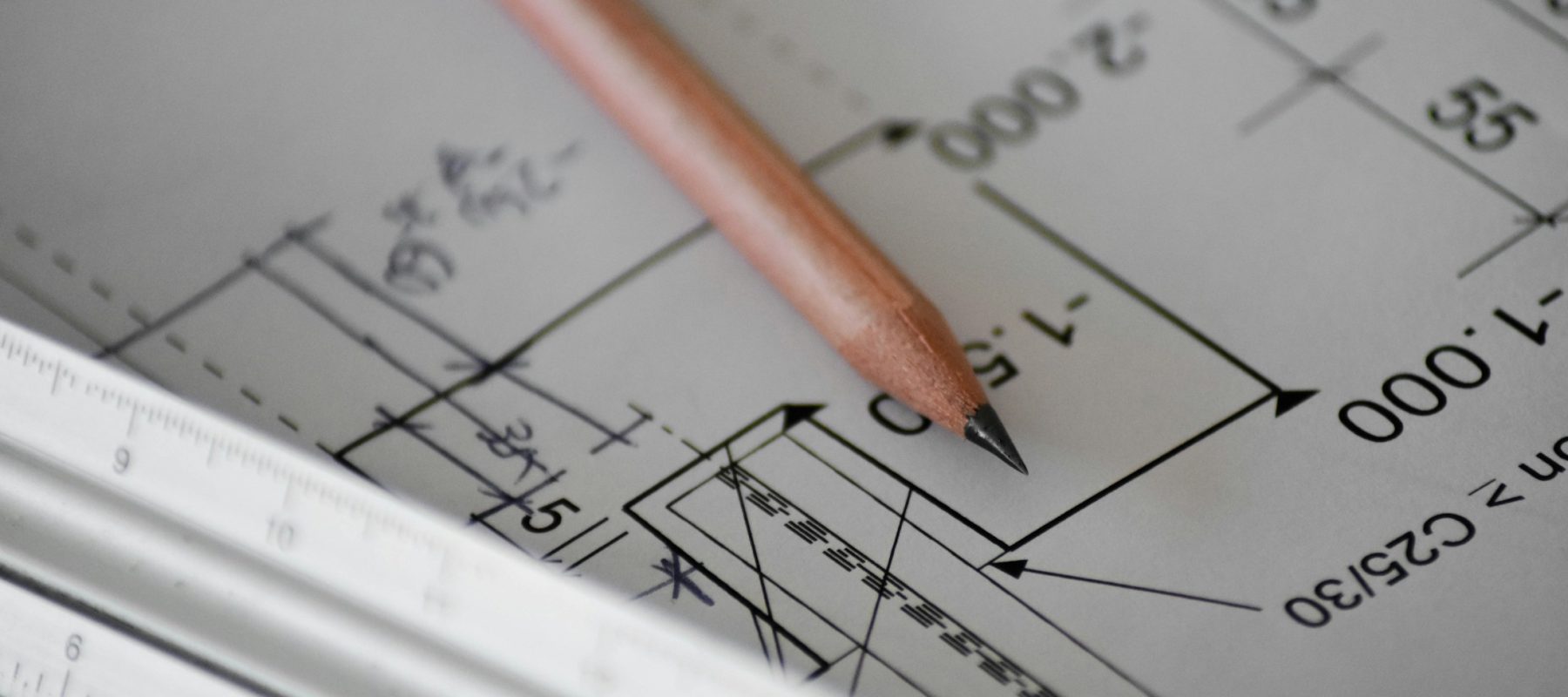 Construction plans and project tools on a work surface